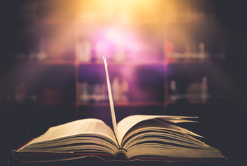 Poster - Stack of books in the library and blur bookshelf background	