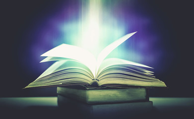 Poster - Imagine a picture book of an ancient book opened on a wooden table with a sparkling golden background. With magical power, magic, lightning around a glowing glowing book In the room of darkness