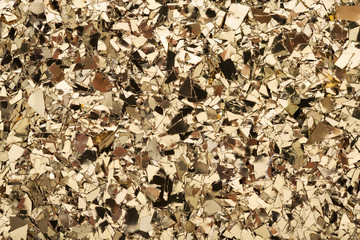 Wall Mural - gold foil confetti on white background. festive, party or holiday glitter backdrop. flat-lay, close-