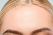 close up of forehead with perfect skin of young woman