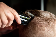 Hairdresser Cuts Man's Hair With Electric Clipper Trimmer.