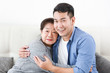 © chayathon2000 - Asian senior grand mother with son happy and smile on the sofa in living room love family concept