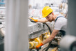 © JustLife - Factory worker. Man with helmet working on wires.