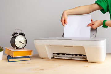 Close up of woman using a printer machine