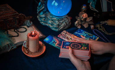 Tarot cards and crystal ball, candles, witch magic bottles . Wicca, esoteric, divination and occult background with vintage magic objects for mystic rituals