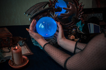 Tarot cards and crystal ball, candles, witch magic bottles . Wicca, esoteric, divination and occult background with vintage magic objects for mystic rituals