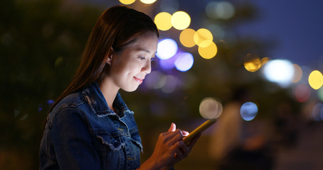 Wall Mural - Woman use of cellphone in city at night