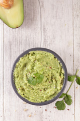 Wall Mural - homemade guacamole with coriander herb in bowl,