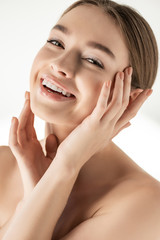 Wall Mural - positive naked smiling girl posing isolated on white