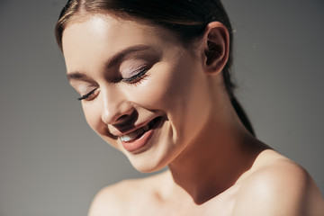 Wall Mural - beautiful naked smiling girl posing isolated on grey