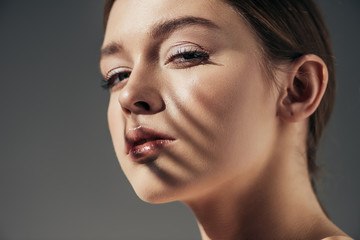 Wall Mural - portrait of girl with shadows on face isolated on grey