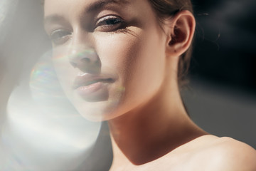 Wall Mural - portrait of attractive nude girl on grey with lens flares