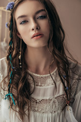Wall Mural - attractive girl with braids in white boho dress on beige