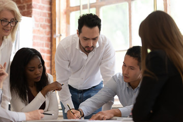 Asian businessman company member explaining project details to diverse team