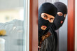 © Robert Kneschke - Burglars open patio door from the house