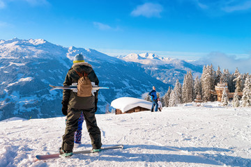 Wall Mural - Man on Snowboard and with ski in Zillertal Arena Austria