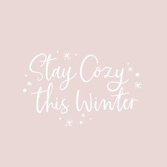 Wall Mural - Stay cozy this winter positive lettering vector illustration. Inspirational handwriting phrase in white color with snowflakes on pastel purple background