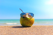 cool holiday coconut with sunglasses on the tropical beach 