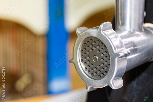 Fotomural close up metal discharge head of meat grinder or mince machine for home or indus