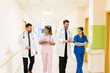 © AntonioDiaz - Medical Team Discussing Together In Hospital Corridor