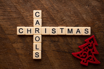 the words christmas carol on wood