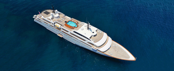 Aerial drone ultra wide photo of luxury mega yacht with wooden deck docked in Aegean island destination deep blue open sea