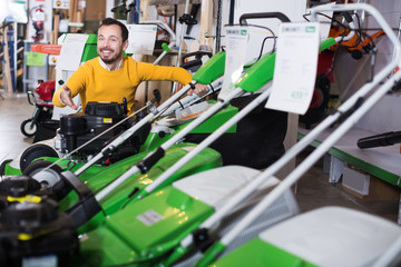 Wall Mural - Man choosing lawnmower