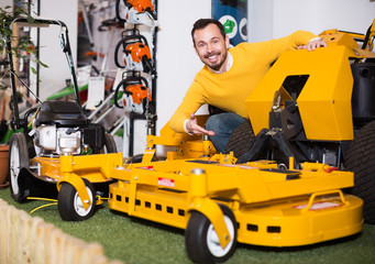 Wall Mural - Man choosing lawnmower