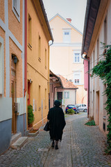 Canvas Print - Senior woman silhouette in Celje old town in Slovenia