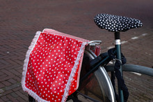 Classic Dutch Bike With Red Saddlebags And Black Seat With White Dots