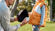 © Svitlana - Support your child. Father teaching son baseball in the park on a sunny day