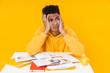 © Drobot Dean - Desparate african teenager boy studying