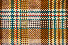 Brown Checkered Fabric With Colored Threads. Scottish Wool. Fabric For Plaid Coat And Suit. Close-up. Background