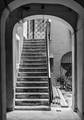 Sticker - Vertical greyscale shot of concrete stairs inside an ancient building