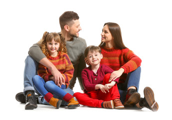 Canvas Print - Happy family in winter clothes on white background