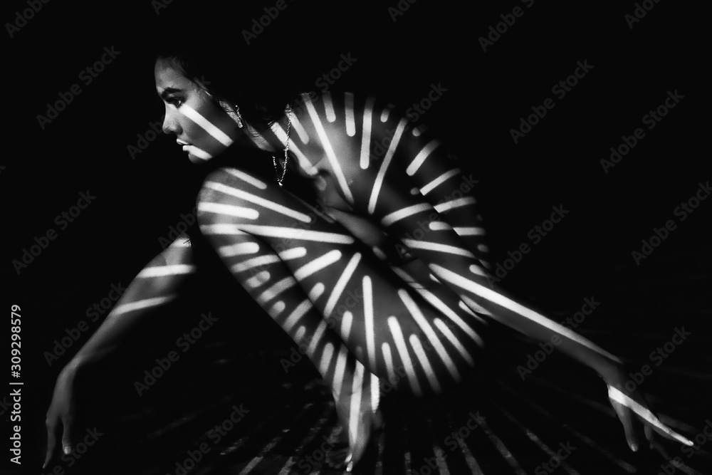 black and white nude art portrait of asian woman with strip of shadow on body Stock Photo