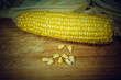 Tutu of corn peeled on a wooden board with grains. Vignette