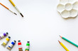 © iamtui7 - top view of brushes, color tubes, pencils and palette on white drawing pad background, copy space, flat lay, paintings art concept