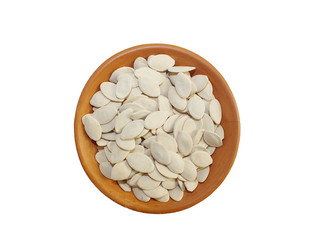 Wall Mural - Dry pumpkin seeds  in terracotta cup on white background.