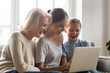 © fizkes - Three generations of women have fun watching video on laptop