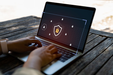 businessman using a laptop computer with technology cybersecurity and privacy concept. protection an