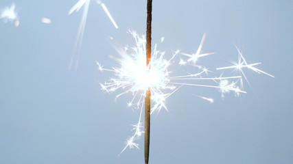 Close-up of firework sparkler burning. Fireworks burn on a blue background