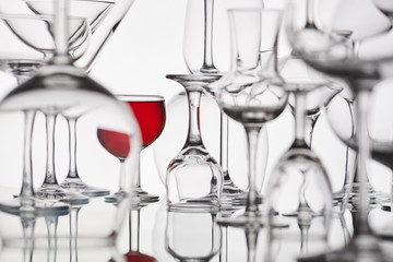 different glasses with a red drink on a white background