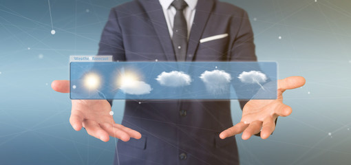 Poster - Businessman holding a Weather Forecast widget 3d rendering