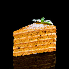 Poster - sweet homemade honey cake on a black wooden table