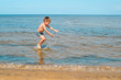 © smspsy - boy swimming in the sea, jumping in the waves of the ocean on the beach