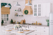 © MZaitsev - Interior of a bright modern kitchen in vintage style, decorated with Christmas decor