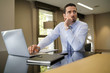 © goodluz - Businessman working on laptop in modern office
