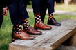 stylish men's socks. Stylish suitcase, men's legs, multicolored socks and new shoes. Concept of style, fashion, beauty and vacation