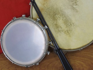 Close-up of two Brazilian percussion musical instruments: “tamborim” with drumstick  and 